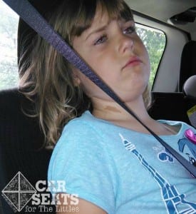 This seat belt in the Dodge Caravan does not come into contact with this child's shoulder making it a dangerous belt fit.