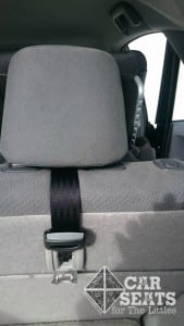 View from the back of a Toyota Prius shows a black forward facing seat properly tethered