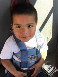 Preschooler in an integrated school bus harness