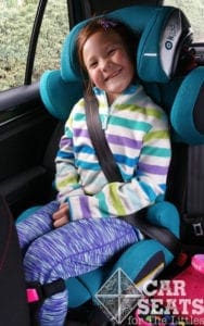 Kiddy Cruiser 3: Smiling 7 year old buckled in to teal booster seat