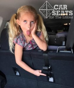 Preschool aged child pointing to tether with her tongue out