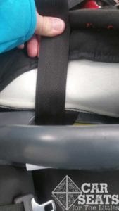Once the belt path is exposed, pull the webbing straight up while applying pressure to the seat pan