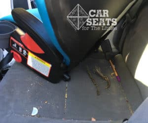 booster pulled away from car's seat to reveal dirt and small items