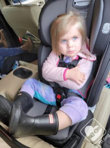 Displeased toddler in her car seat